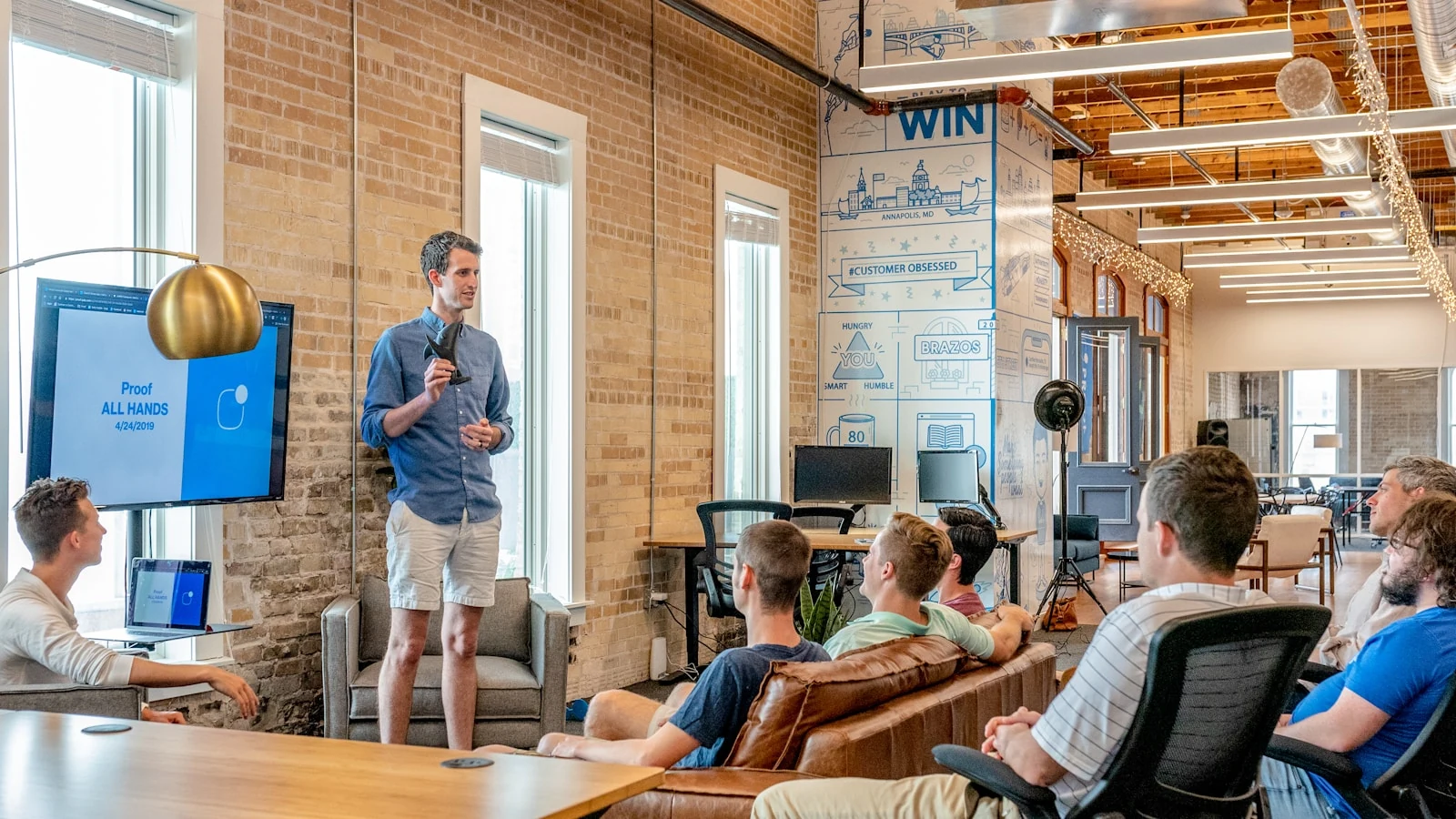 Startup creative team meeting in a bright loft office workspace